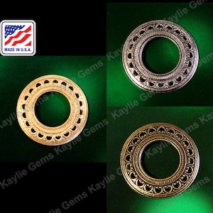 May include: Four metal rings with a decorative design. The rings are in two different finishes: gold and silver. The rings are all the same size and have a circular shape.  MADE IN U.S.A.