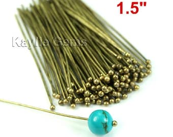 May include: A bundle of 1.5 inch long gold head pins with a turquoise bead on one of the pins.