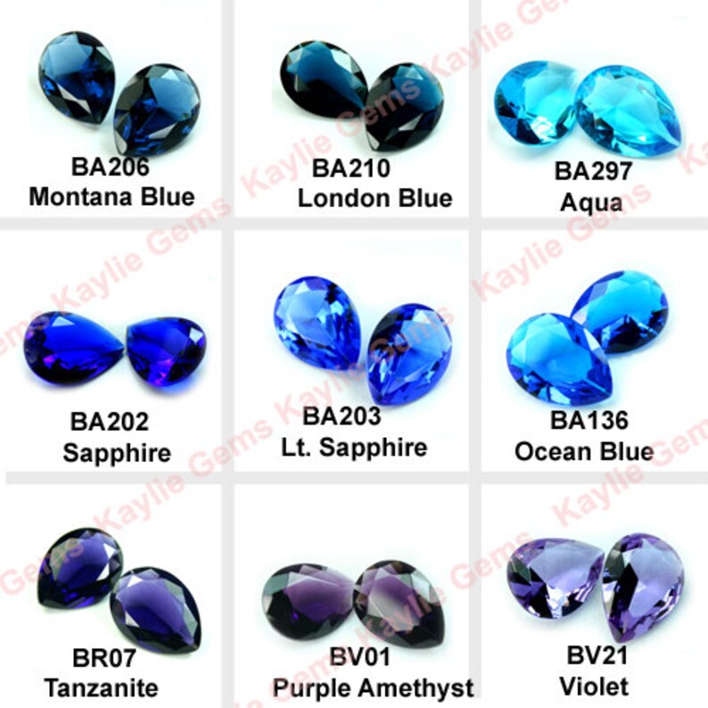 May include: Assortment of pear-shaped gemstones in various shades of blue and purple. The gemstones are labeled with their names and codes, including Montana Blue, Sapphire, London Blue, Lt. Sapphire, Aqua, Ocean Blue, Tanzanite, Purple Amethyst, and Violet.