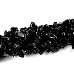 May include: A strand of black obsidian chip beads. The chips are irregular in shape and size, and have a glossy finish.