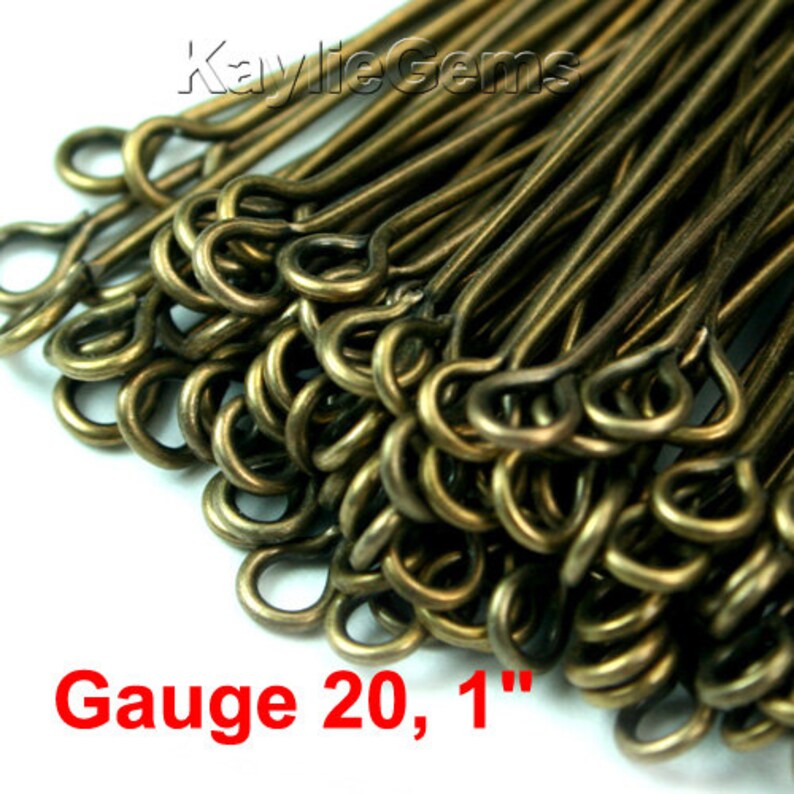 May include: A close-up of a pile of 1-inch long, gold-toned, gauge 20 jump rings. The jump rings are made of metal and have a smooth finish.  Gauge 20, 1"