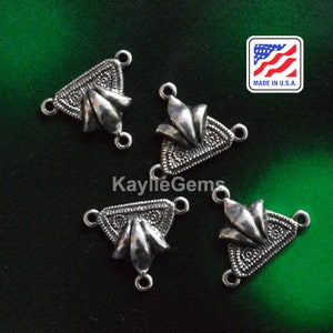 May include: Four silver triangle-shaped jewelry connectors with three loops each. The connectors have a decorative design with a floral motif. Made in the U.S.A.