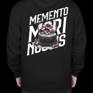 May include: Black hooded sweatshirt with a white graphic design of a snow globe with presents inside. The text "Memento Mori Nous" is printed around the snow globe.