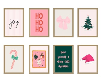 May include: A set of eight framed wall art prints featuring Christmas themes including the text joy, HO HO HO, and have yourself a merry little Christmas, alongside illustrations of a pink bow, a tree, a candy cane, ornaments, and a hat.