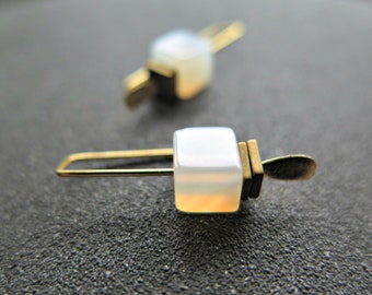 small white carnelian and yellow gold plated earrings with gold hematite stones. unique modern earrings.