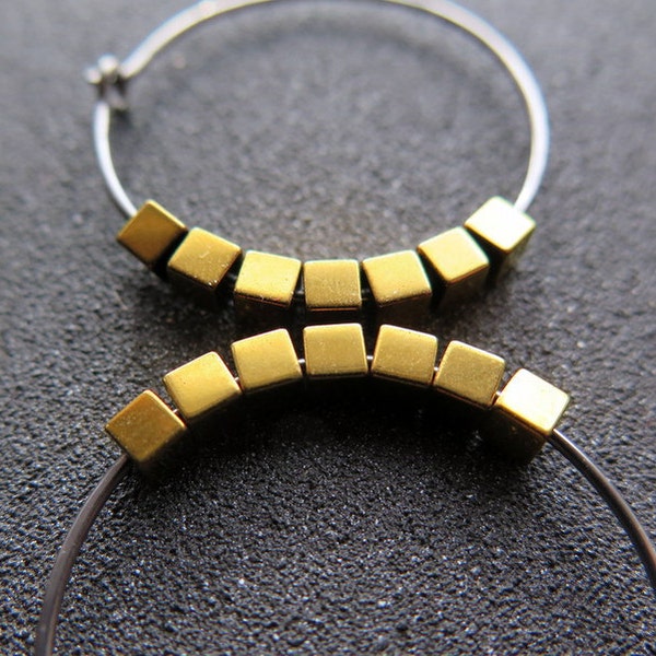 gold and silver earrings. hypoallergenic niobium hoops for sensitive ears.