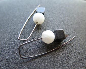 modern moonstone and onyx earrings. niobium wires for sensitive ears. black and white jewelry.