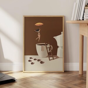 May include: A framed art print featuring a whimsical coffee-themed illustration. It depicts a person floating with an umbrella above a coffee cup, a ladder, coffee beans, and a coffee maker. The color palette includes brown, beige, and orange.