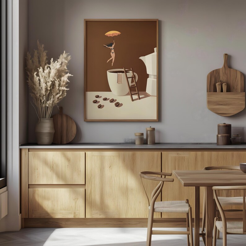 May include: A framed art print depicts a whimsical scene with a woman floating above a coffee cup, holding an orange umbrella. A small wooden ladder leans against the cup, with coffee beans scattered nearby. The artwork is set against a brown background.
