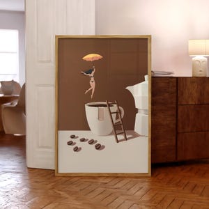 May include: Framed art print featuring a whimsical coffee-themed illustration. A woman with an umbrella floats above a coffee cup, with a ladder and coffee beans nearby. The artwork has a brown and white color scheme, with a wooden frame.