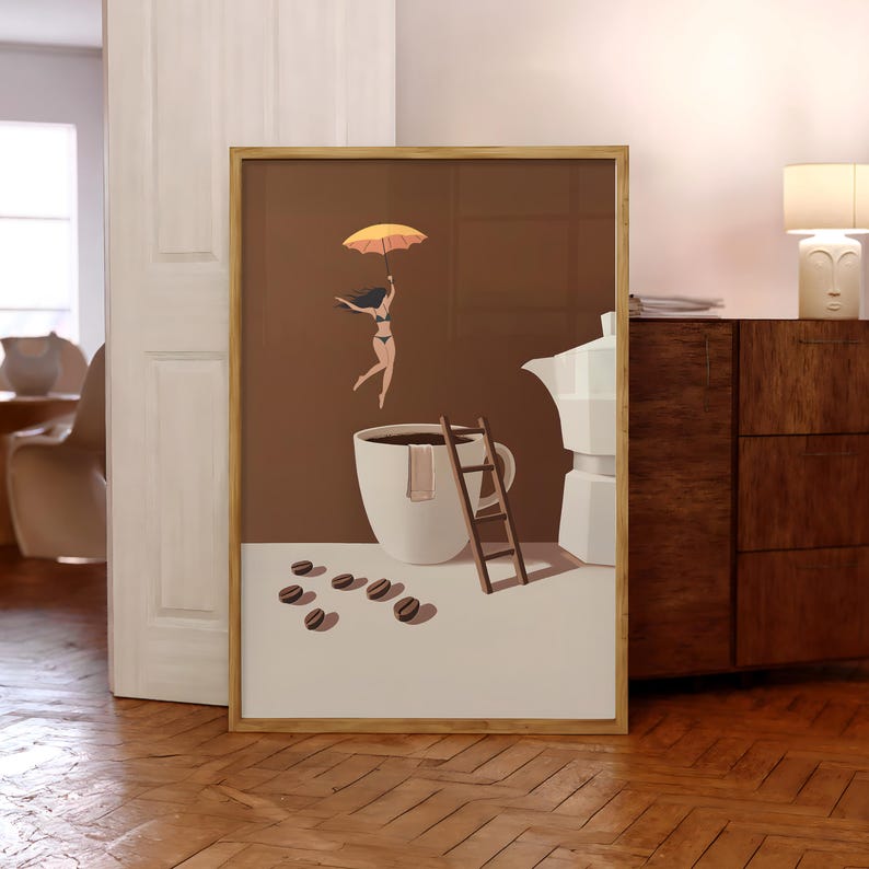 May include: Framed art print featuring a whimsical coffee-themed illustration. A woman with an umbrella floats above a coffee cup, with a ladder and coffee beans nearby. The artwork has a brown and white color scheme, with a wooden frame.
