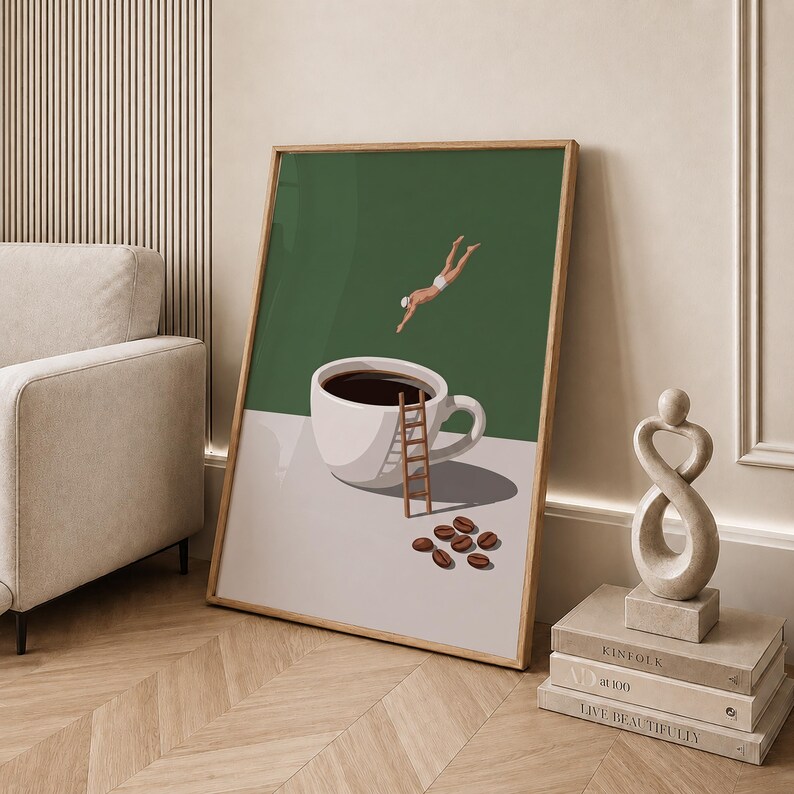 May include: A framed wall art print featuring a white coffee cup filled with dark liquid on a light surface. A small wooden ladder leans against the cup, while a figure in white swimwear dives towards it. Several brown coffee beans lie nearby.