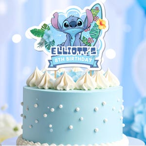 May include: A light blue birthday cake with white frosting and a Stitch-themed topper. The topper reads "ELLIOTT'S 8TH BIRTHDAY" and includes tropical flowers and leaves. The cake is decorated with white pearl sprinkles.