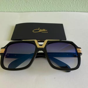 Vintage Cazal Sunglasses: Black & Gold Frame, Blue Lens