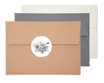 May include: Three envelopes in shades of brown, gray, and white. The front envelope has a round sticker with a watercolor design of succulents and feathers. The envelopes are arranged in a layered format, with the brown envelope in front.