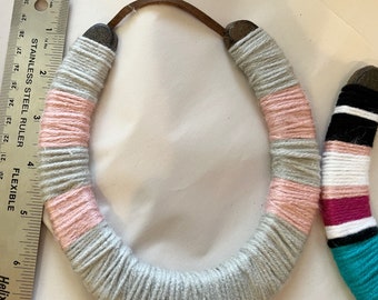 Lovely housewarming gift!  Good luck horseshoe in muted pinks and greys. Complete with leather strap to hang.