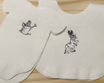 Baby shirt shaped or bib shaped linen-like paper napkins featuring Peter Rabbit.  Baby shower napkins. Pack of 16.