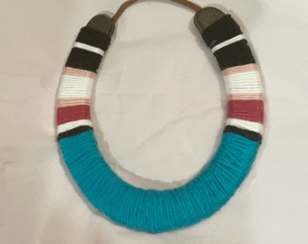 Lovely housewarming gift!  Good luck horseshoe in rich colors. Complete with leather strap to hang.