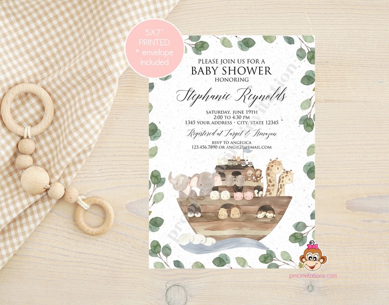 May include: A baby shower invitation with a watercolor illustration of a wooden ark with animals on it. The invitation is printed on a textured paper with a green eucalyptus leaf border. The text on the invitation reads "Please join us for a baby shower honoring Stephanie Reynolds. Saturday, June 19th, 2:00 to 4:30 PM, 1345 Your Address - City, State 12345. Registered at Target & Amazon. RSVP to Angelica 123.456.7890 or angie2email.com."