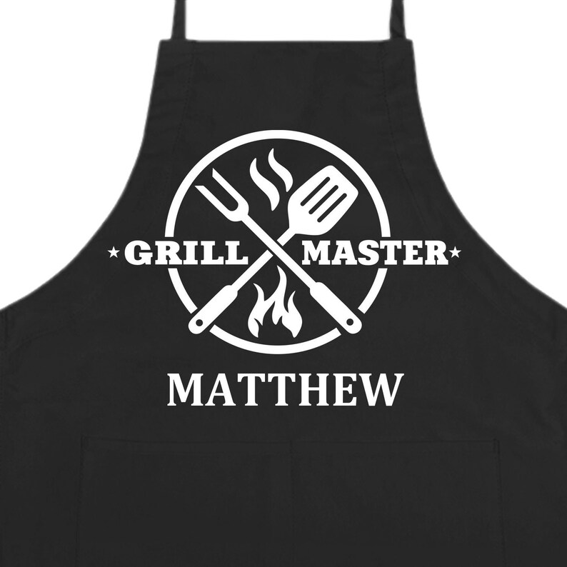 May include: Black grilling apron with a white circle design featuring crossed grilling tools, flames, and the text "Grill Master". The name "Matthew" is printed below the circle.