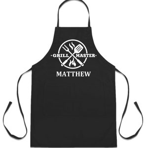 May include: Black apron with a white logo that says "Grill Master" and a crossed spatula and fork with flames. The name "Matthew" is printed below the logo.
