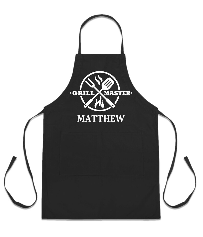 May include: Black apron with a white logo that says "Grill Master" and a crossed spatula and fork with flames. The name "Matthew" is printed below the logo.