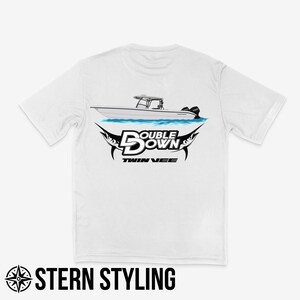 May include: White t-shirt with a graphic of a boat and the text "Double Down Twin Vee" on the back.