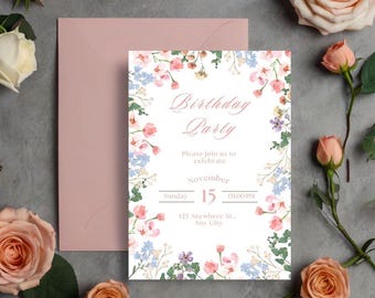 以下が含まれることがあります： 白い背景にピンクとブルーの花が咲いた、花の誕生日パーティーの招待状。テキストには「Birthday Party」、「Please join us to celebrate」、「Sunday」、「November 15」、「01:00 PM」、「123 Anywhere St., Any City」と記載されています。