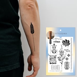 May include: A sheet of temporary tattoos featuring black and white designs related to Ukraine. The designs include a wheat stalk, a maple leaf, a trident, a QR code, and the words "Воля Незалежність" (Freedom Independence) in Ukrainian. The sheet also includes the text "TATTOOSHKA BY @RADARTTTT" and "L8-178".