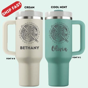 May include: Two insulated travel mugs, one cream and one cool mint, each with a handle and a lid. The cream mug has "Bethany" printed on it, and the cool mint mug has "Olivia" printed on it. Both mugs feature a yarn ball and crochet hook design.
