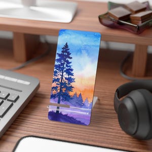 May include: A watercolor painting of a tall pine tree in a forest at sunset. The sky is a gradient of blue, orange, and purple. The trees are silhouetted against the sunset.