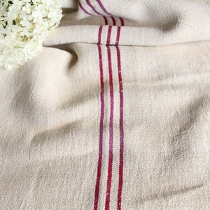 May include: A white linen fabric with three thick, burgundy stripes running vertically down the center.