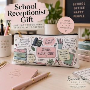 May include: A rectangular white pencil case featuring colourful illustrations of office supplies and speech bubbles with text including "School Receptionist," "Have you checked the website?," "Let me just find out," and "The printer has chosen violence today."