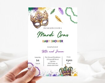 May include: A Mardi Gras themed baby shower invitation with a gold and purple mask, green beads, and gold feathers. The invitation reads "Please join us for a Mardi Gras Baby Shower in honour of Katie and Jenna. Saturday, 1st March, The Howard Residence, 52 Emerald Street, Fairview, RSVP Katie on 0000000000, From 4 pm till late."