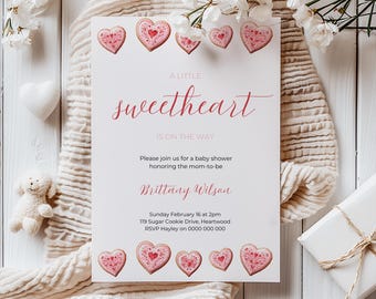 May include: A white baby shower invitation with pink hearts and the text "A Little Sweetheart is on the Way". The invitation includes the name "Brittany Wilson", the date and time of the shower, the address, and the RSVP information.