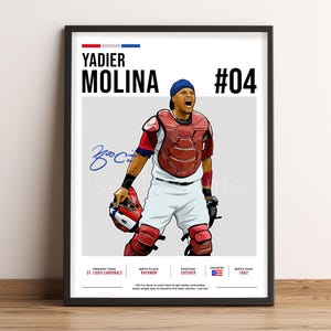 May include: Framed print of baseball player Yadier Molina in catcher's gear. The artwork includes his name, number 04, and a signature. The St. Louis Cardinals logo is also visible. The print is in a black frame.