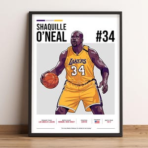 May include: A framed poster featuring a stylized illustration of Shaquille O'Neal in a Los Angeles Lakers uniform, number 34. The poster includes text with his name, team, birth details, and a quote. The color scheme is predominantly yellow and purple.