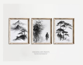 Op de afbeelding: Drie ingelijste kunstdrukken met zwart-wit Aziatische landschapsschilderijen. De prenten tonen bergen, bamboe en bomen in een minimalistische stijl. De lijsten zijn lichtbruin. De tekst "DREAMSCAPE PRINTS DIGITAL MASTERPIECES" staat onderaan.