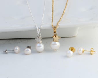 May include: Two necklaces and two pairs of stud earrings featuring white freshwater pearls. One necklace has a silver-tone chain and star charm, while the other has a gold-tone chain and star charm. Each earring pair matches the respective metal tone.