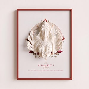 Peut inclure: Une affiche encadrée représentant un relief sculptural blanc d'une divinité aux bras multiples tenant un trident. Le design inclut un fond circulaire avec des accents floraux rouges. Le texte indique : SHAKTI Devi, The divine feminine energy that powers creation and transformation.