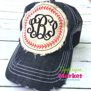 May include: A black distressed denim trucker hat with a white mesh back. The hat features a white and red embroidered baseball patch with a monogram in the center.