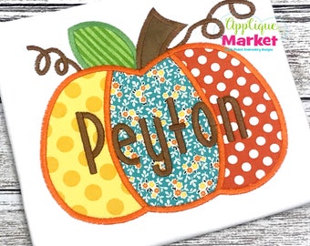 May include: A personalized pumpkin applique design with the name Peyton in brown lettering. The pumpkin is made of different fabric patterns, including yellow with white polka dots, teal with white floral print, and orange with white polka dots.