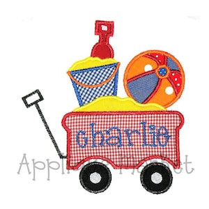 May include: Red wagon with a black handle, filled with a blue and white bucket, a red and orange beach ball, and a red bottle. The wagon has a red and white checkered pattern and the name "Charlie" is written on the side.