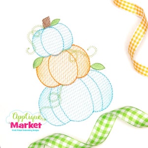 May include: A stack of three embroidered pumpkins in blue, orange, and green. The pumpkins are stacked on top of each other and have a brown stem on top.