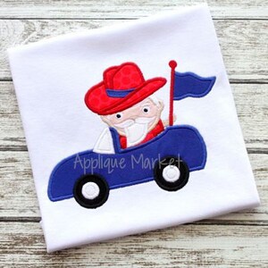 May include: Embroidered design of a cartoon character wearing a red and white cowboy hat driving a blue car with a blue flag.