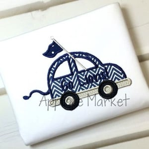 May include: Embroidered design of a blue car with a chevron pattern and the text "Go Lions!" on the side. The car has a flag on top and is on a white background.