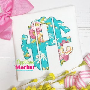 May include: A turquoise floral monogram with a scalloped edge. The monogram is made up of the letters "HPE" and is appliqued on a white fabric.