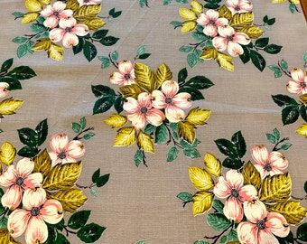 May include: A gray fabric with a repeating pattern of pink and white flowers with green and yellow leaves.
