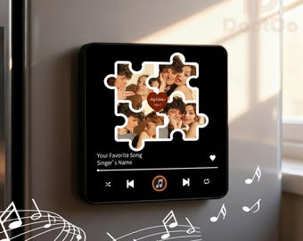 May include: Black square magnet with a puzzle piece design featuring a collage of photos. The magnet includes text that reads "Your Favorite Song" and "Singer's Name." A music player interface is displayed at the bottom.