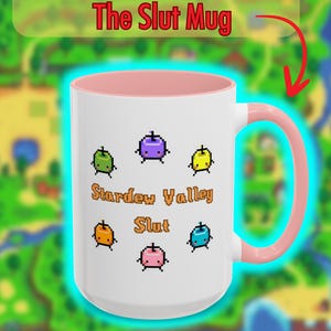 May include: White ceramic mug with a pink interior and handle. The mug features pixelated fruit graphics and the text "Stardew Valley Slut." The mug also has the text "No one forced you to increase EVERYBODY'S hearts. But you did it anyways."